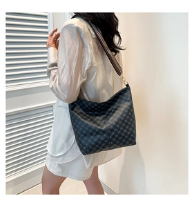Detail of vintage patterned bucket bag with wide colorful woven shoulder strap for women