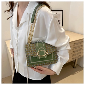 Detail showing green tweed patchwork bag with white stitching and gold chain strap