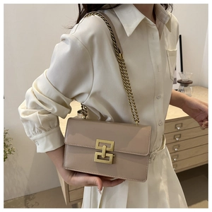 Elegant beige chain shoulder bag with gold metal buckle shown on a model for daily use