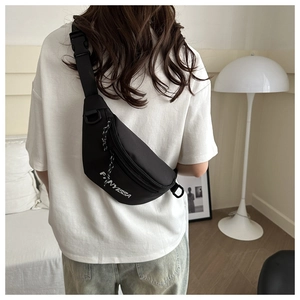 Close-up of black nylon chest bag featuring FANYISSA logo and woven zipper pulls