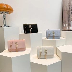 Minimalist square shoulder bags in four colors on display with gold S-logo and chain strap