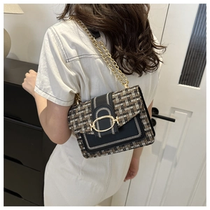 Detail of woven tweed crossbody bag with gold chain strap and metallic lock buckle