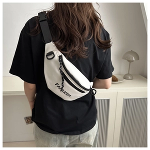 Close-up of white oxford fabric chest bag with black adjustable strap and plastic buckle
