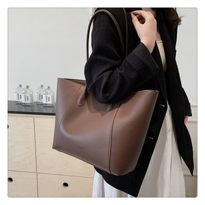 Détail du cuir grainé marron foncé sur un grand sac cabas fourre-tout spacieux