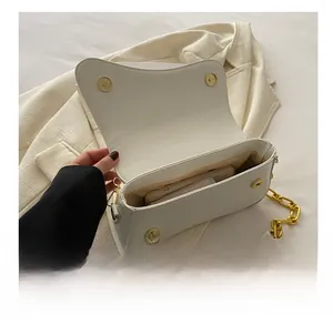 Detail showing the spacious interior capacity of the white matte leather shoulder bag