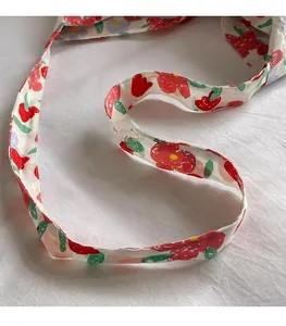 Detail showing the floral print long shoulder strap made of soft cotton canvas fabric