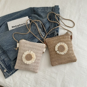 Straw woven crossbody bags with sun flower detail in cream and khaki colors