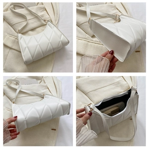 Detail view of white quilted shoulder bag showing diamond texture and inner capacity