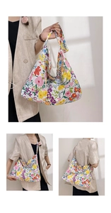 Close-up of floral pattern and wide shoulder strap on a large canvas tote bag