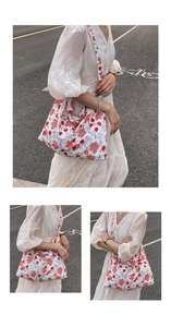 Detailed view of the large floral tote bag showing its volume and drape on a model