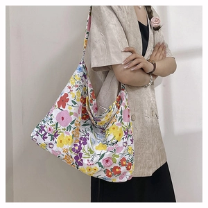 Detail of floral nylon tote bag featuring colorful flower patterns and spacious interior