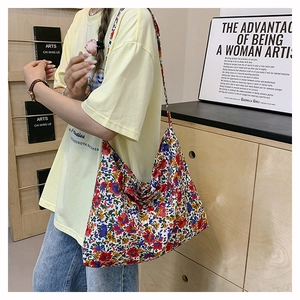 Macro detail of a large capacity floral nylon shoulder bag with colorful pattern