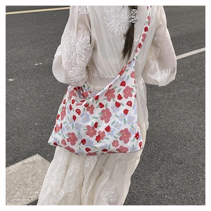 Floral canvas tote bag carried by model showing the spacious design and floral pattern