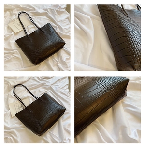 Macro detail of dark brown crocodile pattern texture and structure of the tote bag