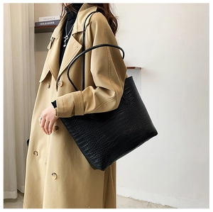 Detailed view of black crocodile pattern tote bag shown as a stylish underarm shoulder bag