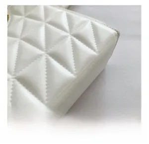 Detail view of premium white matte leather with iconic triangle quilting and fine stitching