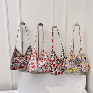 Floral canvas tote bags in four patterns on metal display stand for women