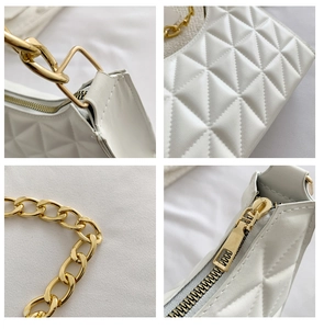 Detail of white quilted handbag with golden chain strap and precise stitching