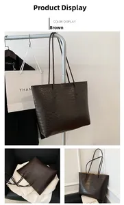 Macro shot of dark brown tote bag showing detailed faux crocodile leather texture