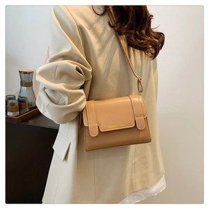 Close-up of caramel PU leather crossbody square bag with gold Fashion & Bags lettering