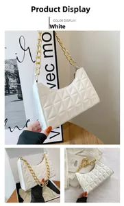 Detailed view of white quilted hobo bag with thick gold chain strap and luxury texture