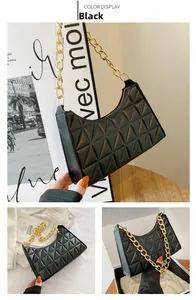 Detail of black quilted leather shoulder bag featuring chunky gold chain strap and zipper