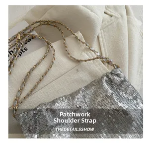 Close-up of sparkling silver sequin bucket bag with braided chain shoulder strap detail