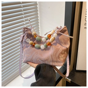 Detail of light purple marble tote bag featuring colorful bead handle and drawstring closure