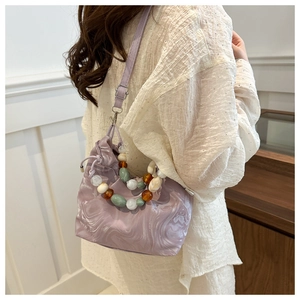 Detail of lavender marble pattern bucket bag with colorful acrylic bead handle and strap