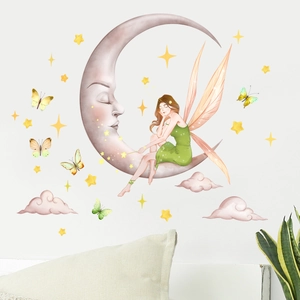 Detailed view of fairy sitting on a green glowing moon wall decal with stars and butterflies