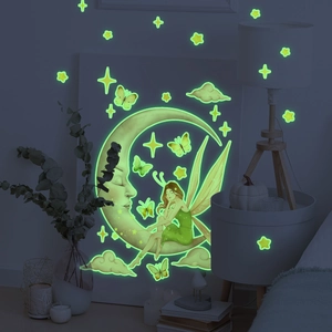 Glow in the dark wall stickers featuring fairy, moon, and stars in a cozy bedroom scene