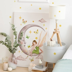 Detail showing cartoon moon fairy, stars, and butterflies glowing wall stickers for nursery
