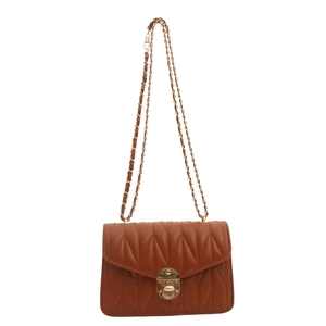 Caramel quilted leather crossbody bag with V-shaped stitching and gold chain strap