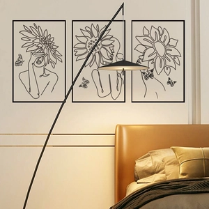 Close-up of three minimalist wall art panels featuring floral line art woman silhouettes