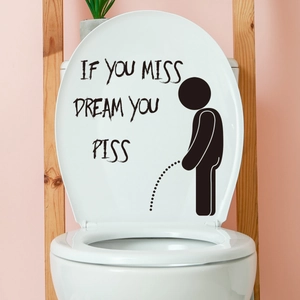 Close-up of funny stick figure toilet sticker with creative English slogan on white lid