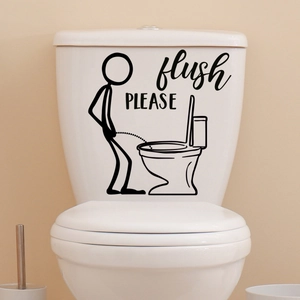 Detail view of funny little man toilet sticker with flush please text on white surface