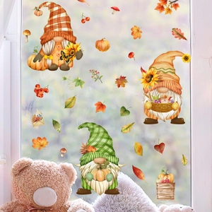 Close-up of autumn gnome window stickers with pumpkins and maple leaves on glass