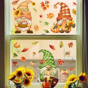 Detail of autumn window stickers with gnomes, sunflowers and pumpkins on glass