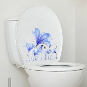 Detail of blue floral self-adhesive wall stickers applied to a white toilet lid