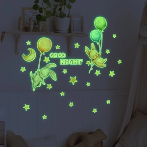 Luminous wall stickers featuring cartoon rabbits, stars, and moon glowing in the dark night