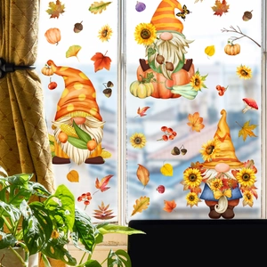Detail of autumn gnome window stickers with sunflowers and maple leaves on bright glass