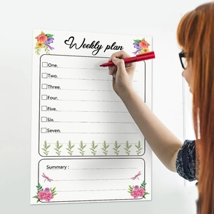 Weekly planning whiteboard sticker with floral designs and red marker for wall organization