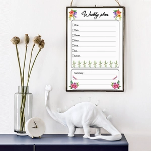 Weekly plan wall sticker with floral design and 7-day checklist in a black frame