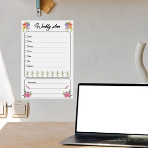 Macro detail of a floral weekly plan wall sticker on a white wall in a home office setup