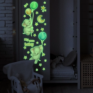 Luminous baby elephant and moon wall stickers glowing in a dark cozy nursery room