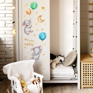 Detailed view of baby elephant and balloon wall stickers applied on a white wardrobe