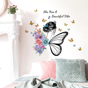 Detail view of floral wall sticker with butterflies and She Has A Beautiful Vibe quote