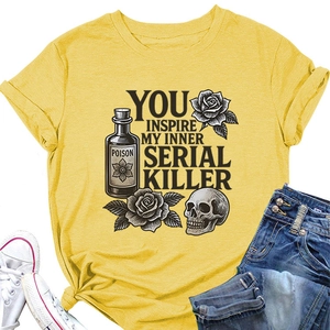 Detailed flat lay of mustard yellow t-shirt with poison bottle and rose graphic print