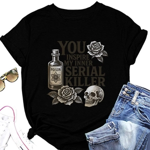 Flat lay of black gothic T-shirt with skull and rose print with fashion accessories