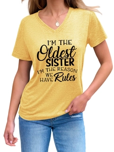 Detail of yellow V-neck t-shirt featuring bold black I'm The Oldest Sister typography print